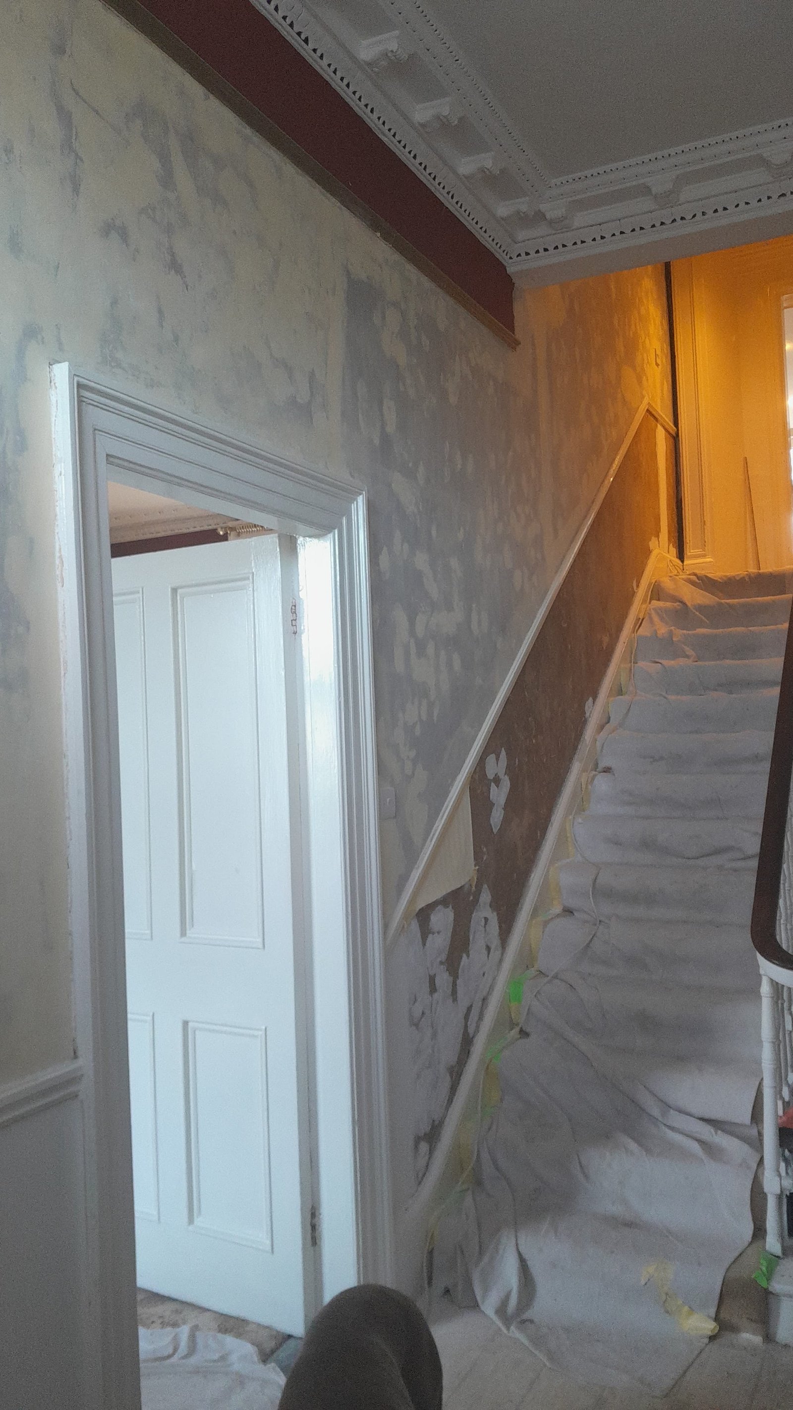 Walls being replastered and painted